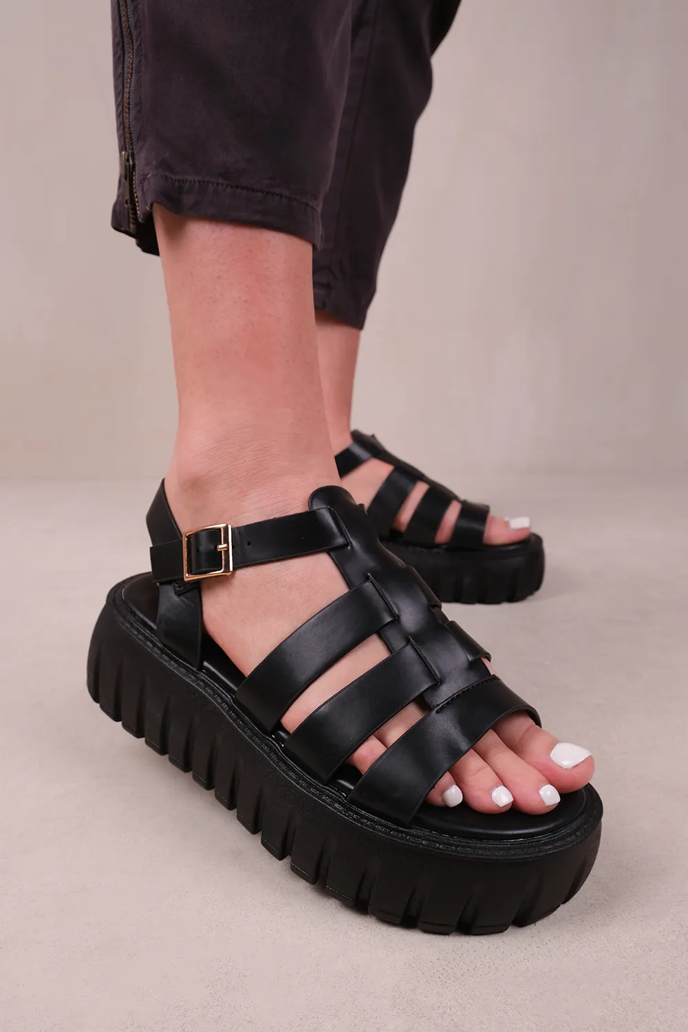 ELIXIR STRAPPY FLATFORM SANDALS IN BLACK FAUX LEATHER